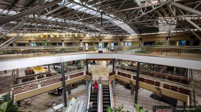 A handful of customers go about their business at Centrepoint Bandar Utama in Damansara Utama.
